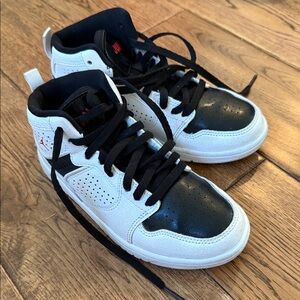 Size 1Y kids Nike Jordans in white and black.